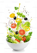 Fresh mixed salad ingredients tossed with olive oil drizzle