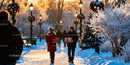 Couple walking with Christmas gifts on snowy park path