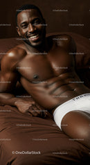 Smiling muscular man relaxing on bed in white underwear