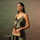 Elegant Woman in Satin Dress with Brown Handbag and Gold Jewelry