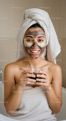 Young Woman Applying Clay Facial Mask in Spa Treatment