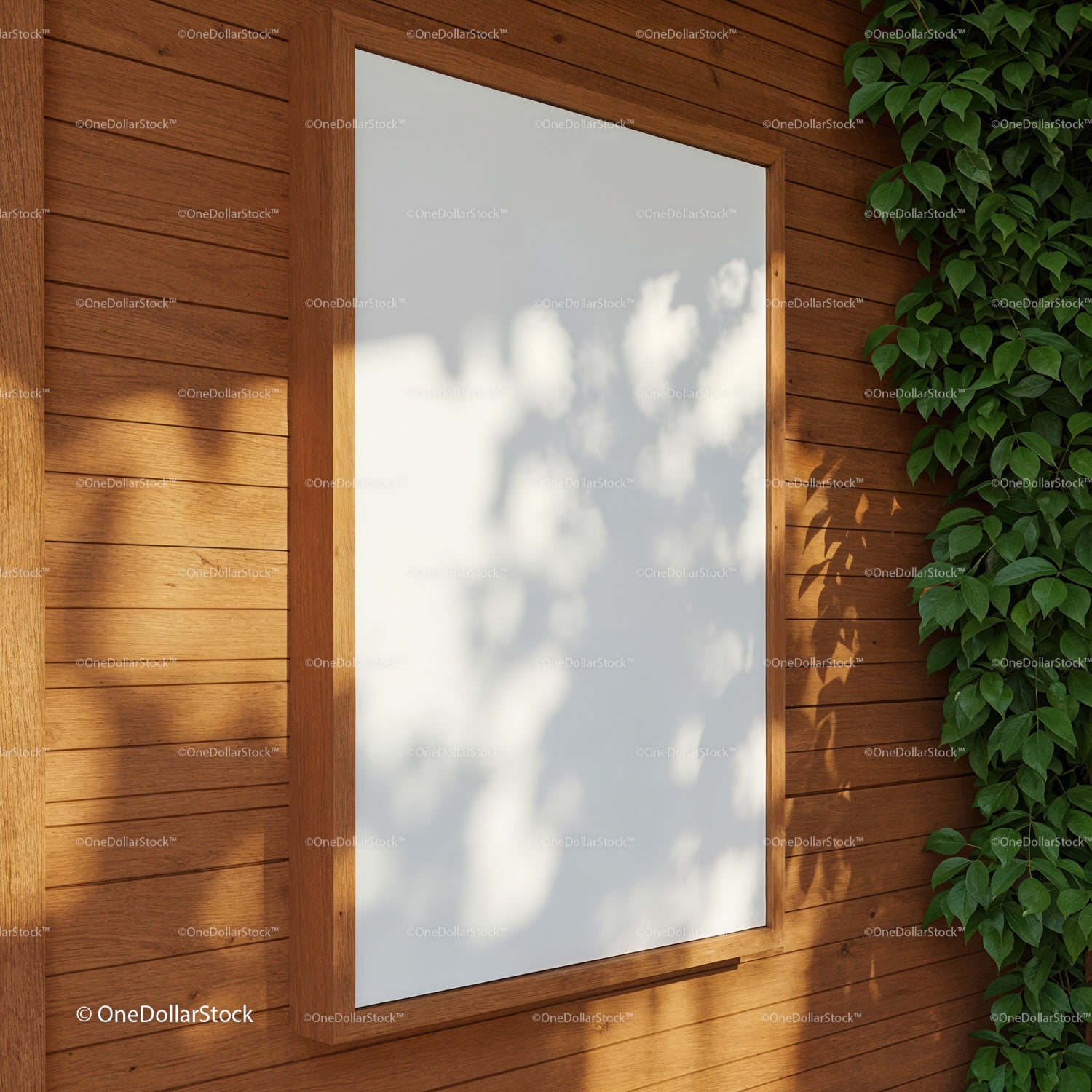 Blank white poster frame on wooden wall with vine