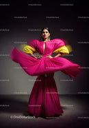 Fashion Model in Vibrant Pink and Yellow Flowing Gown