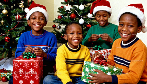 Joyful children in sweaters opening Christmas gifts