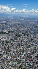 Aerial View of a Modern City with Tall Buildings and Cloudy Sky