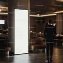 Man in Suit Standing Near Large Empty Lighted Display Panel