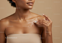Close-up of Woman Applying Sunscreen Lotion on Shoulder for Sun Protection