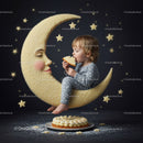 Toddler in pajamas eating cake on crescent moon