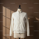 Minimalist white jacket on mannequin with soft shadows