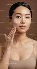 Young Asian Woman Applying Facial Cream with Smooth Porcelain Skin