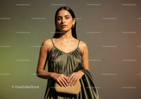 Elegant Fashion Portrait of a Woman in Stylish Dress with Gold Jewelry