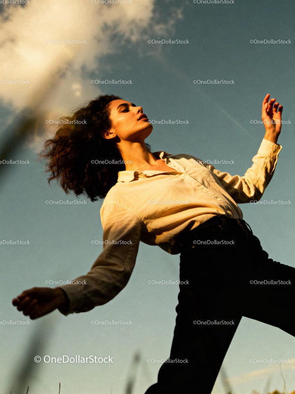 Young woman embracing golden hour outdoors