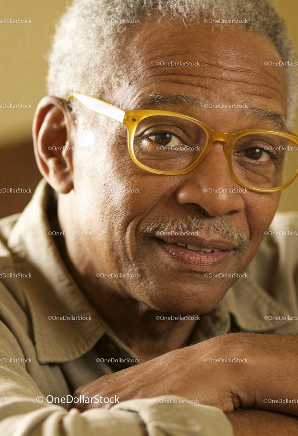 Smiling elderly man wearing yellow glasses close-up