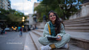 Young Woman Smiling Sitting on Steps with Tablet in City Park