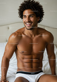 Smiling Fit Man Relaxing on Bed in Bright Bedroom