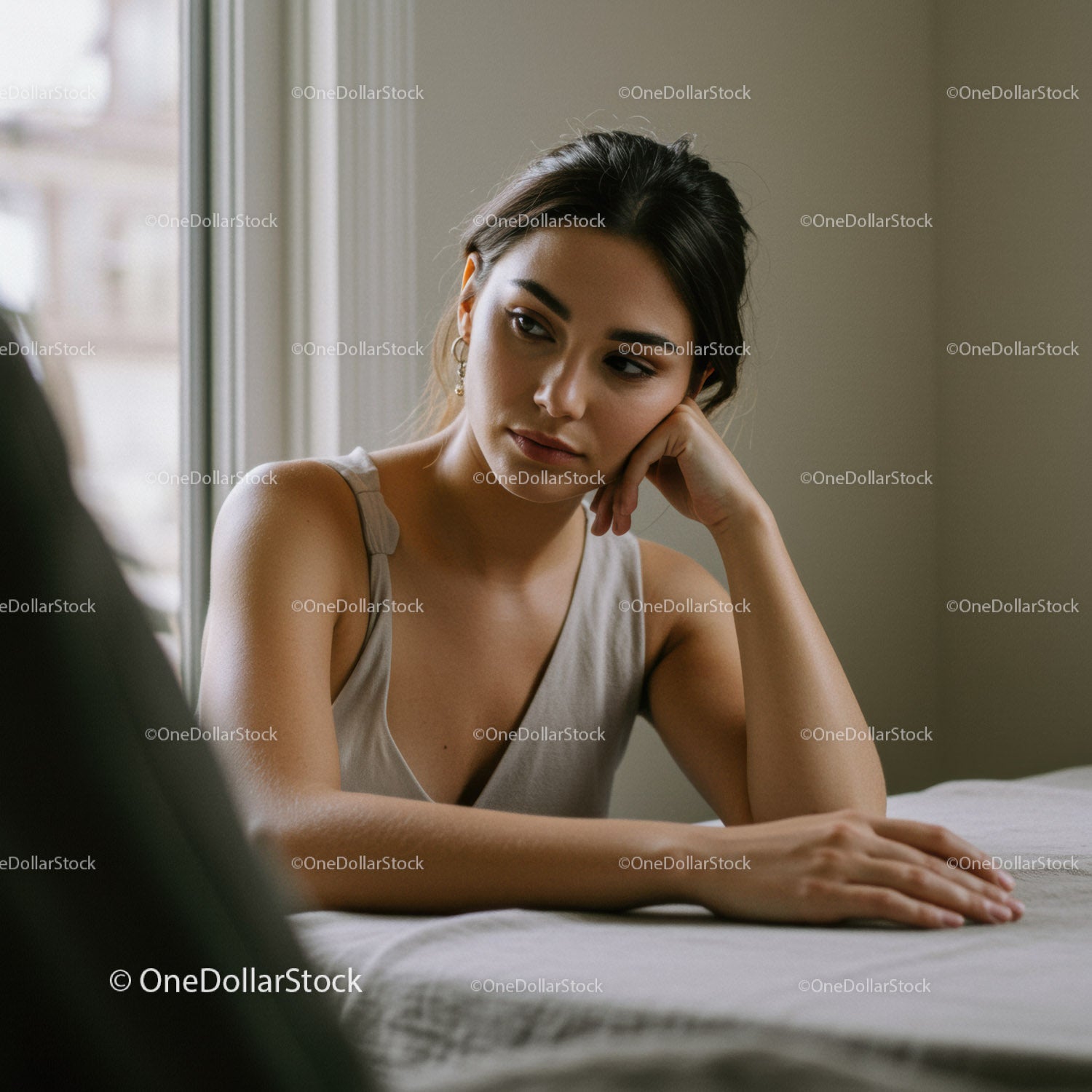 Young Woman Sitting Indoors Reflecting Calmly with Natural Light
