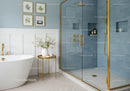 Elegant bathroom with blue tiled shower and freestanding tub
