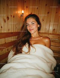 Beautiful Woman Relaxing in Cozy Wooden Sauna for Wellness and Spa
