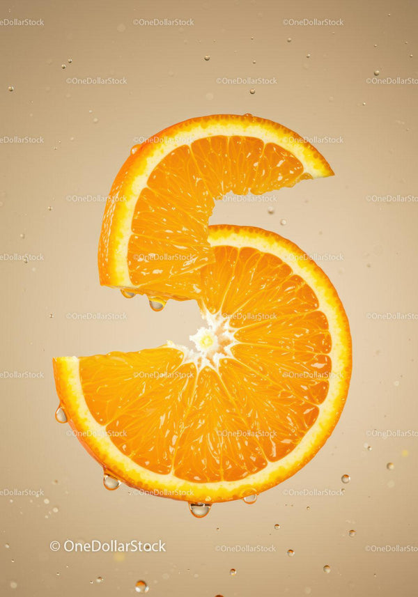 Fresh orange slice submerged in clear water droplets