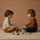 Two Young Boys Playing with Wooden Blocks Indoors