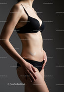 Elegant Woman in Black Lingerie with Toned Abs and Graceful Pose