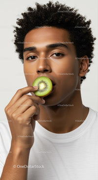 Young Man Holding Kiwi Fruit in Close-Up Portrait for Healthy Lifestyle