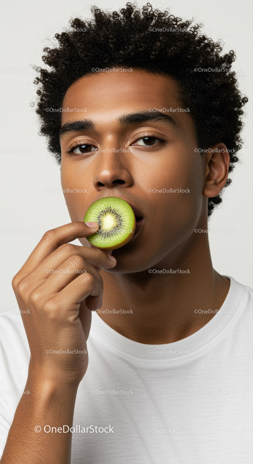 Young Man Holding Kiwi Fruit in Close-Up Portrait for Healthy Lifestyle