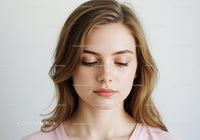 Young Woman with Natural Makeup and Soft Expression in Portrait