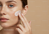 Close-Up of Woman Applying Moisturizer on Face with Flawless Skin