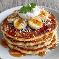Stack of Pancakes with Bananas and Syrup on White Plate