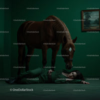 Woman Lying on Floor Beside a Horse in Dramatic Green Room