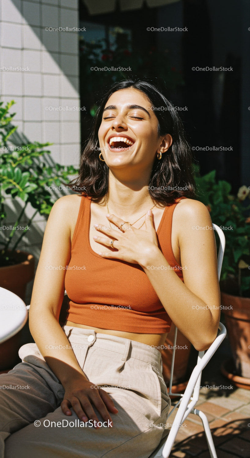 Happy Woman Laughing Outdoors in Sunlight Wearing Stylish Casual Outfit