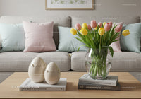 Fresh tulips in glass vase on modern living room table