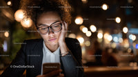 Businesswoman Engaged with Smartphone in Night Urban Setting
