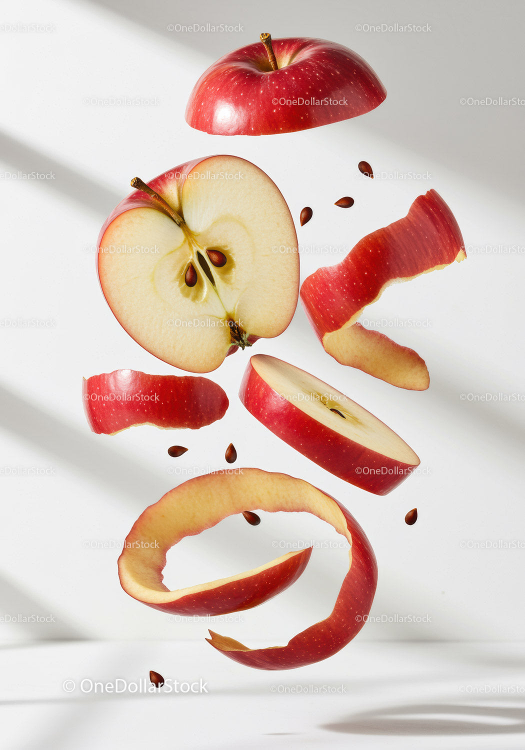 Red apple slices and peel floating with seeds