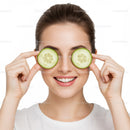 Cheerful Woman with Cucumber Slices Covering Her Eyes for Fresh Skincare