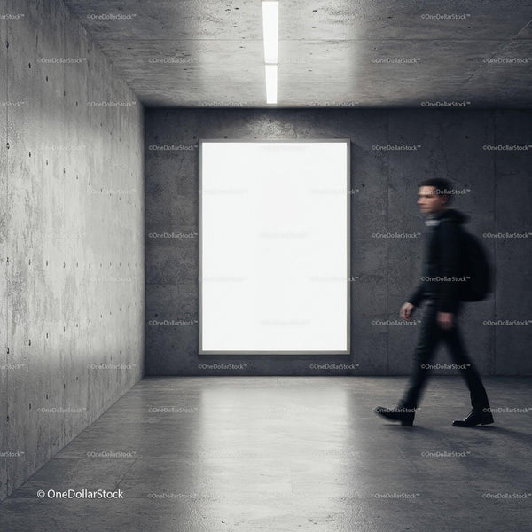 Young man walking past large blank display in modern space JPG Mockup Image