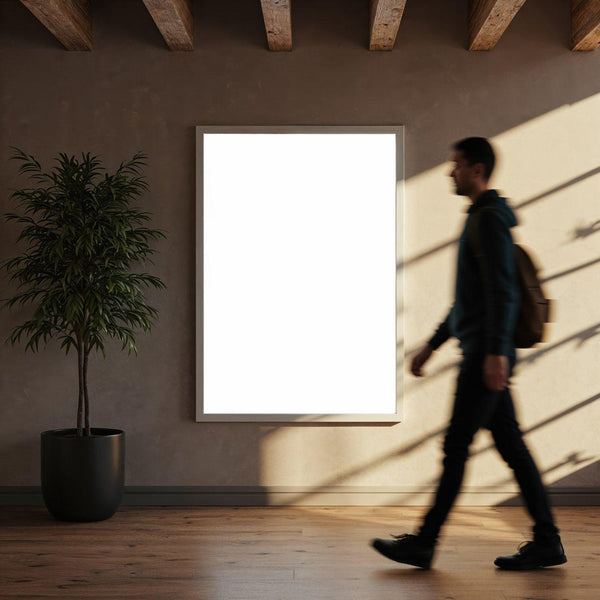 Man walking past blank poster in modern interior JPG Mockup Image