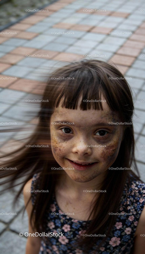 Smiling Girl with Freckles and Windblown Hair Outdoors