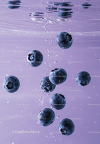 Fresh blueberries immersed in clean water with bubbles