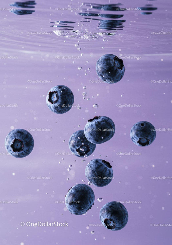 Fresh blueberries immersed in clean water with bubbles