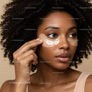 Close-up of a woman with under eye patches applying skincare routine