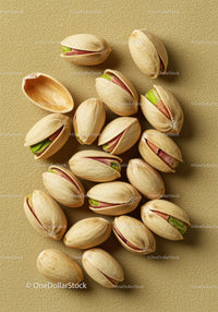Close up of shelled pistachio nuts on textured surface