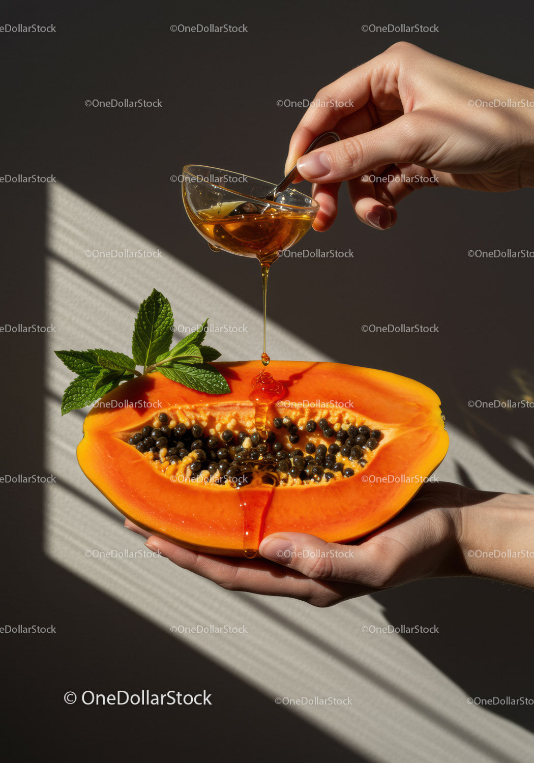 Fresh Papaya Half Drizzled with Honey and Mint Leaves