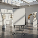 Blank easel in modern gallery with classical sculptures