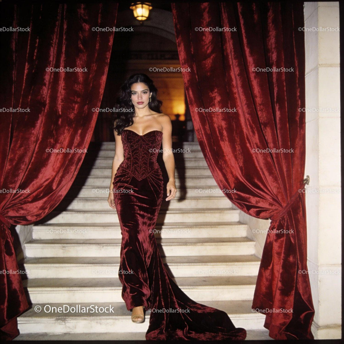 Elegant woman walking down grand staircase in velvet gown