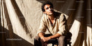 Thoughtful young man sitting in warm natural light