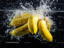 Yellow Bananas Splashing into Water Creating Fresh and Vibrant Scene