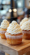 Delicious Vanilla Frosted Cupcakes on Wooden Serving Board