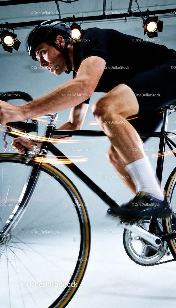 Focused cyclist training intensely on indoor track